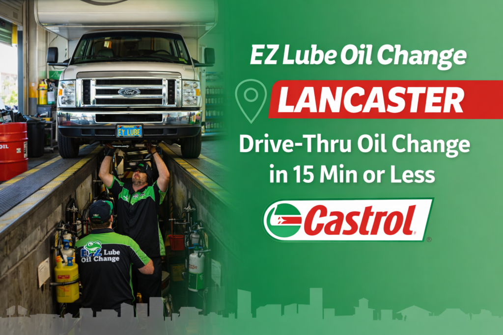EZ Lube Oil Change technicians performing a drive-thru oil change over the service pit in Lancaster, CA using premium Castrol motor oil with customers staying in their vehicle.